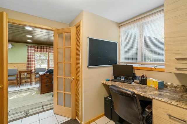 tiled office space featuring built in desk