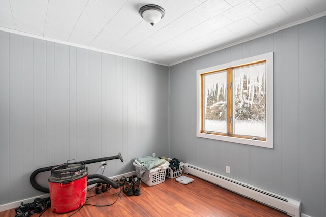 miscellaneous room featuring hardwood / wood-style floors, ornamental molding, and baseboard heating