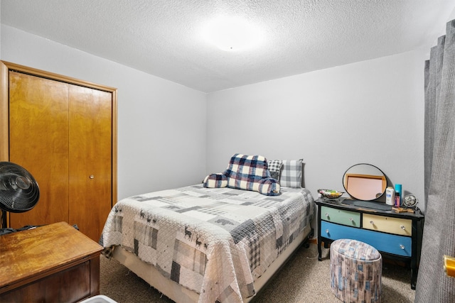 carpeted bedroom featuring a closet and a textured ceiling