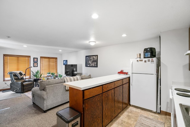 kitchen featuring white appliances and kitchen peninsula