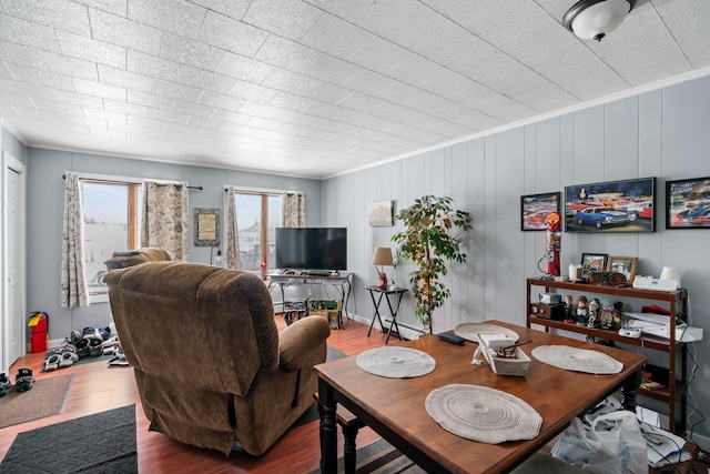 dining space with ornamental molding and wood-type flooring