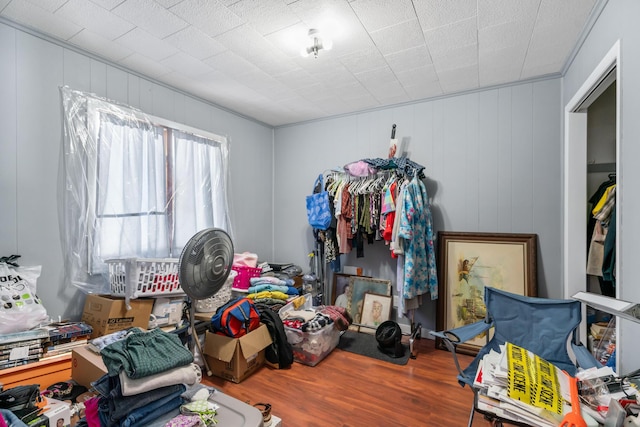 bedroom with ornamental molding and wood-type flooring