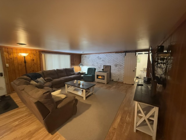 living room featuring brick wall and hardwood / wood-style floors