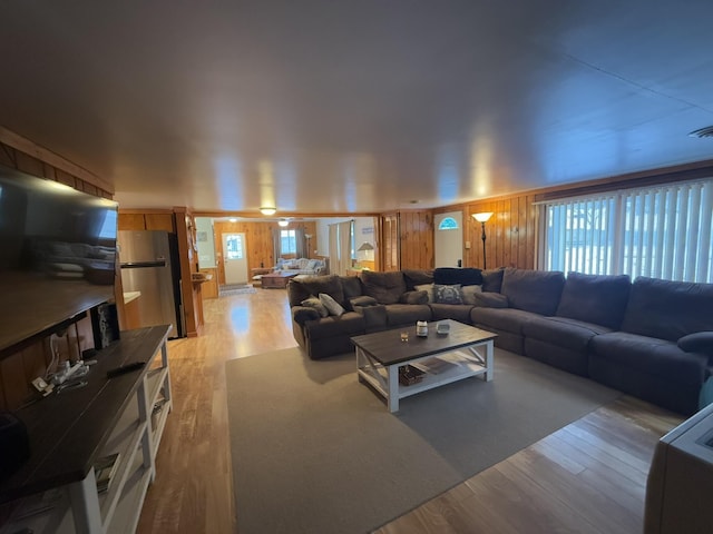 living room featuring wooden walls and light wood-type flooring