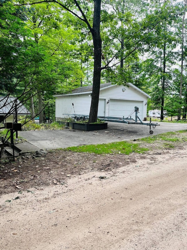 view of side of property with a garage and an outbuilding