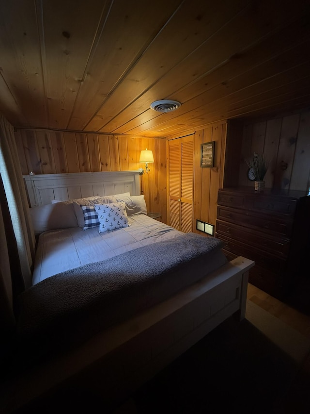 bedroom featuring wood ceiling and wooden walls