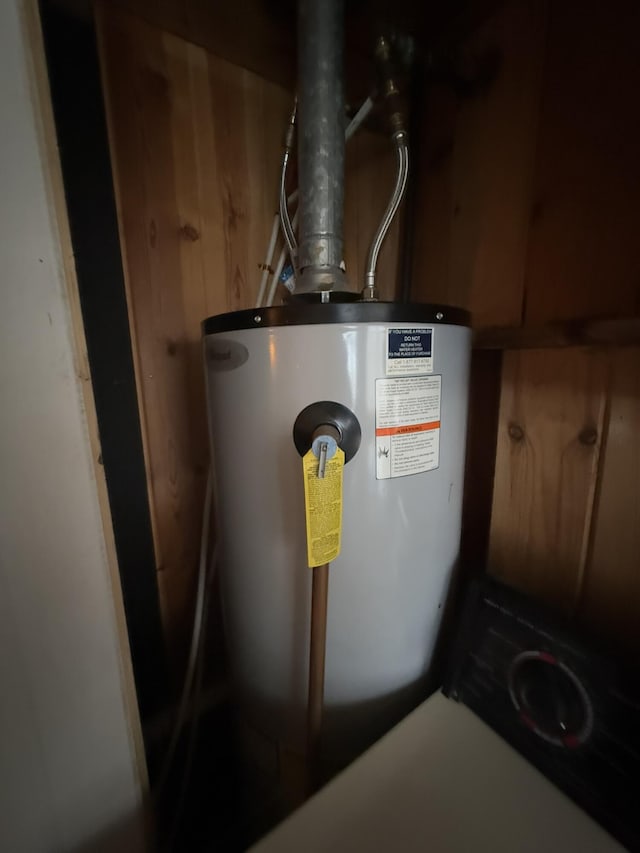 utility room featuring water heater