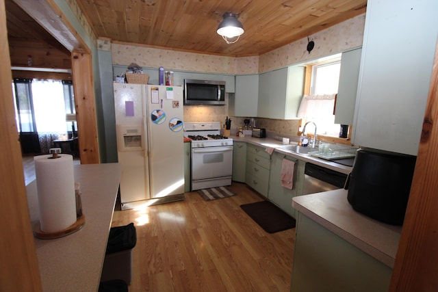 kitchen with sink, white cabinetry, wooden ceiling, appliances with stainless steel finishes, and light hardwood / wood-style floors