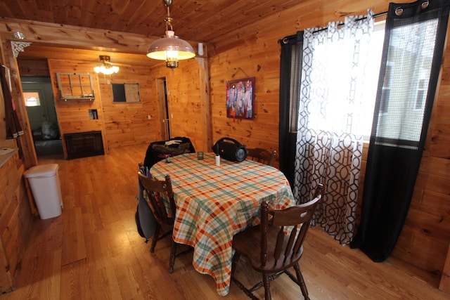 dining area with wood ceiling, a wealth of natural light, and light wood-type flooring