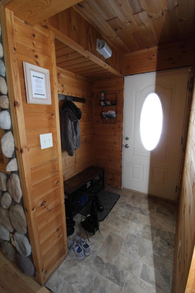 mudroom featuring wood ceiling and wood walls