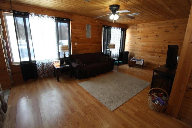 living room featuring wooden walls, hardwood / wood-style floors, and wood ceiling