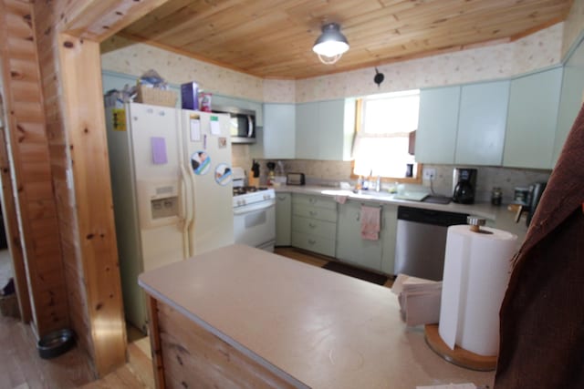 kitchen featuring white cabinetry, sink, stainless steel appliances, wooden ceiling, and light wood-type flooring