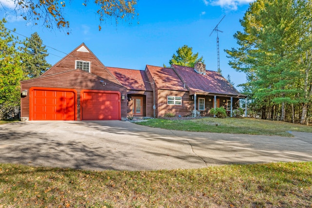 view of front of home with a garage and a front lawn