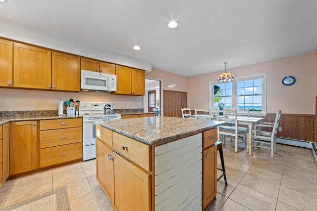 kitchen featuring light tile patterned flooring, a breakfast bar, a kitchen island, pendant lighting, and white appliances