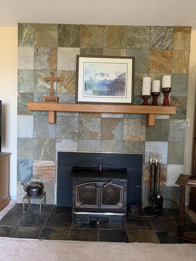 room details with a textured ceiling and a wood stove