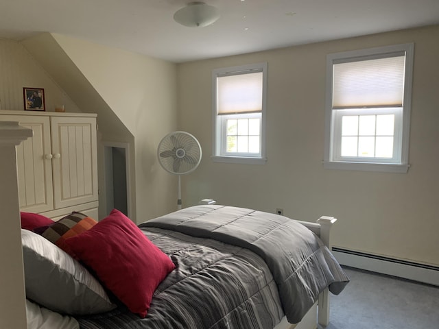 bedroom with a baseboard radiator and light colored carpet