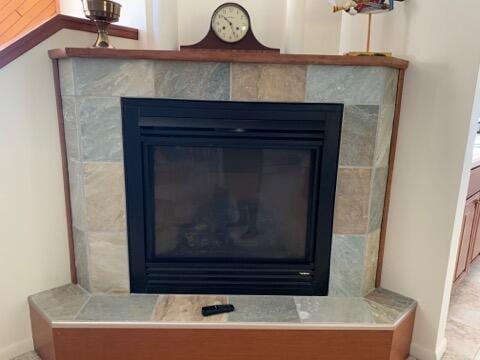 interior details featuring a tiled fireplace