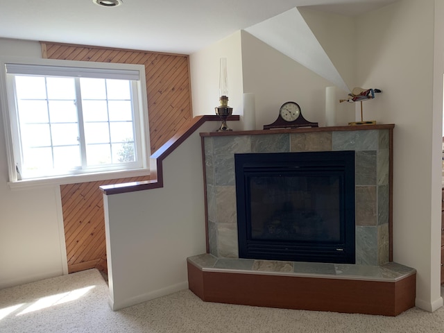 room details with a fireplace and wood walls