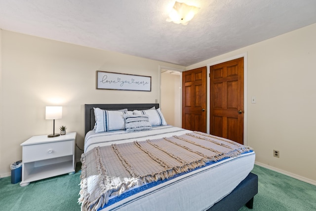 carpeted bedroom featuring a textured ceiling