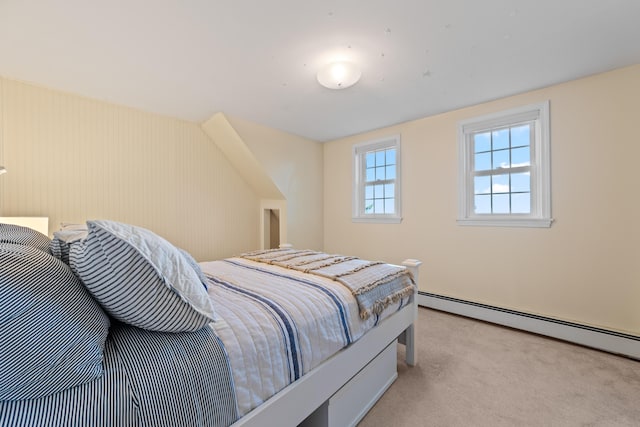 carpeted bedroom featuring a baseboard heating unit