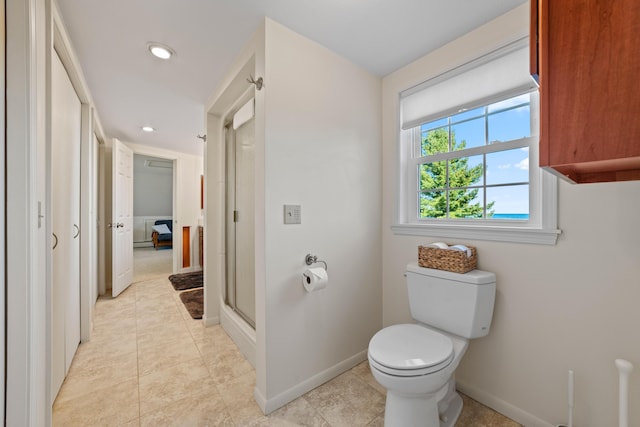 bathroom featuring walk in shower, toilet, and tile patterned flooring