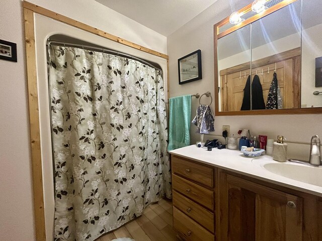 bathroom with vanity, wood-type flooring, and walk in shower