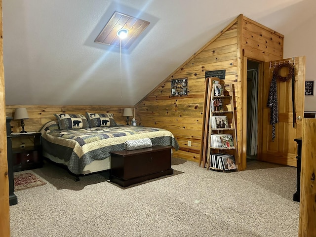 carpeted bedroom with lofted ceiling and wood walls