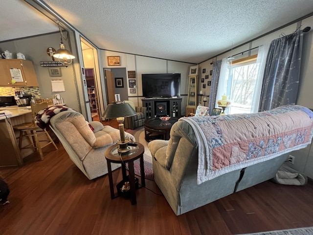 living room with lofted ceiling, dark hardwood / wood-style floors, and a textured ceiling