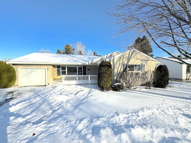 ranch-style house featuring a garage and covered porch