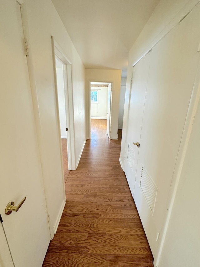 corridor with hardwood / wood-style floors