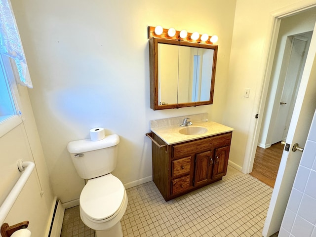 bathroom with vanity, a baseboard radiator, and toilet