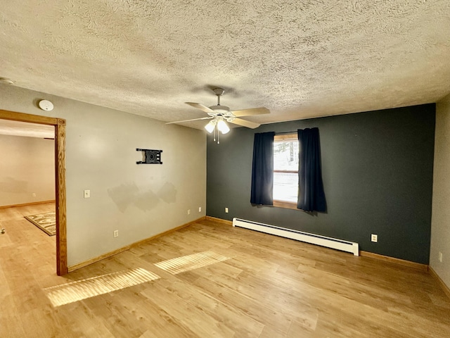 spare room featuring hardwood / wood-style flooring, ceiling fan, a textured ceiling, and a baseboard heating unit