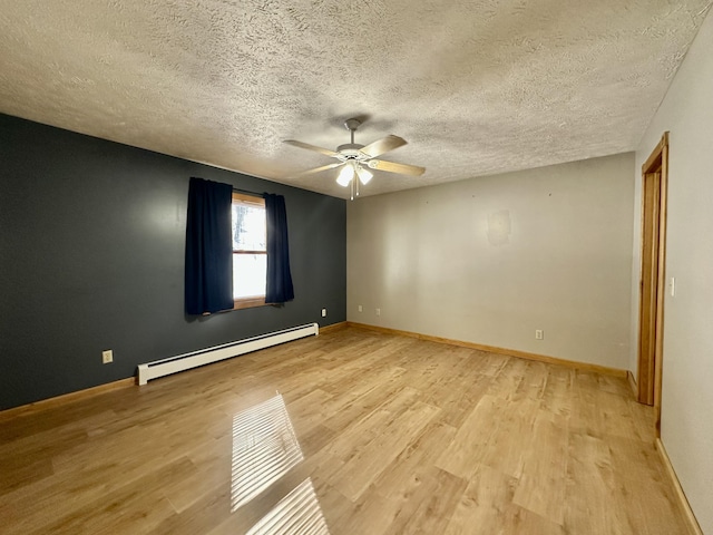 empty room with ceiling fan, light wood-type flooring, a textured ceiling, and a baseboard heating unit