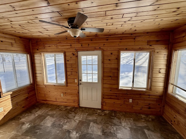 unfurnished sunroom with wood ceiling and ceiling fan