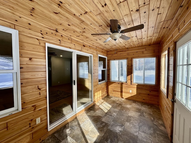 unfurnished sunroom with wood ceiling and ceiling fan