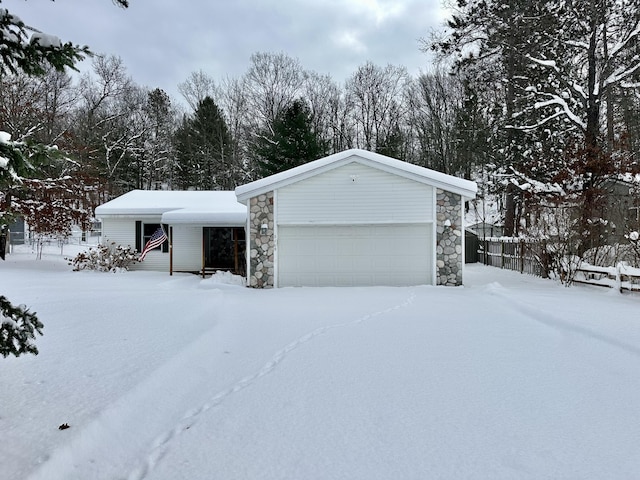 view of front of house with a garage and an outdoor structure