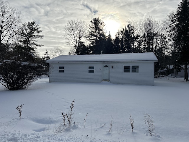 view of snow covered rear of property