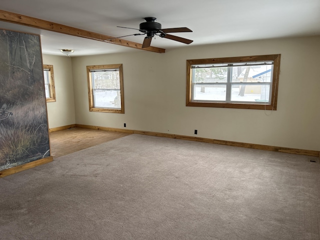 unfurnished room featuring light carpet, ceiling fan, and beamed ceiling