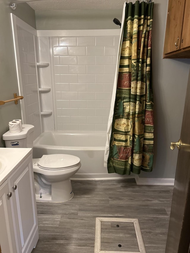 full bathroom featuring wood-type flooring, toilet, shower / bath combo with shower curtain, and vanity