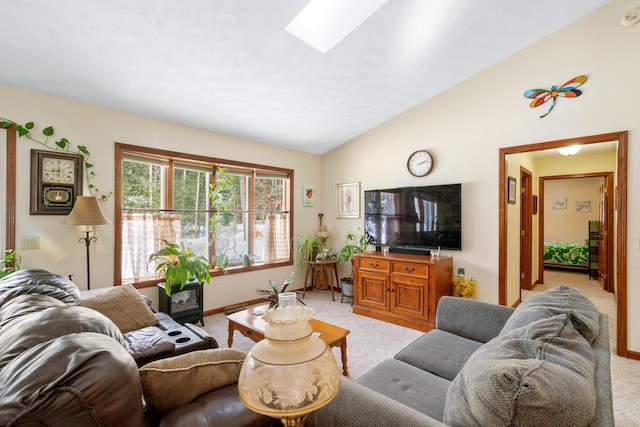 carpeted living room featuring lofted ceiling with skylight