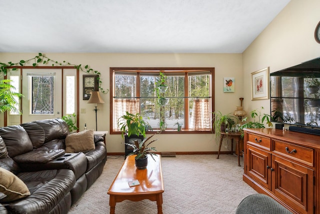 living room featuring lofted ceiling and light carpet