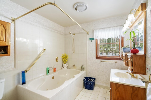 full bathroom with toilet, tiled shower / bath, tile walls, vanity, and tile patterned flooring