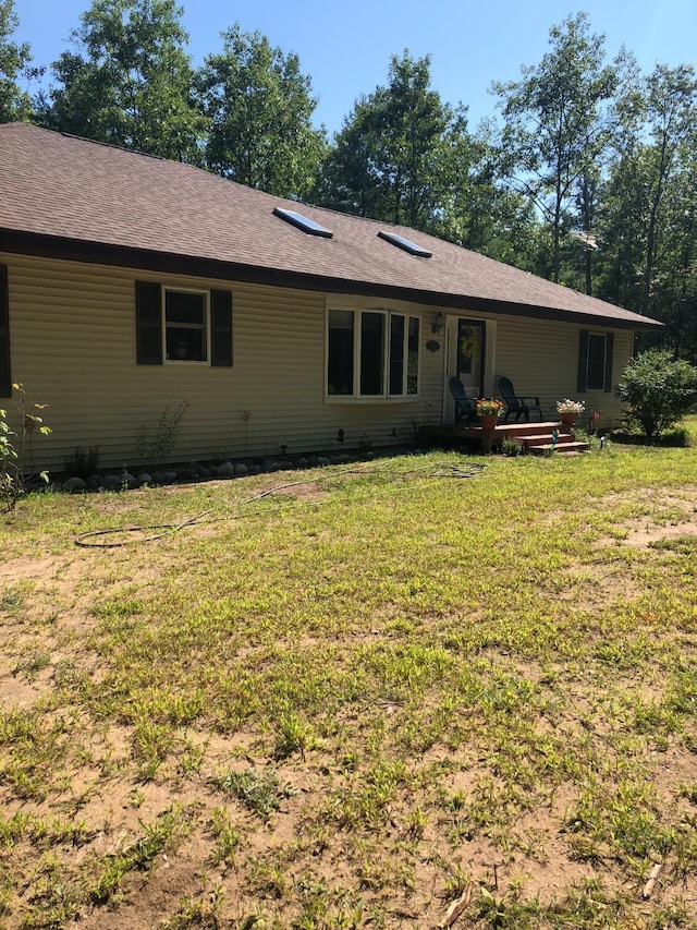 rear view of house with a lawn