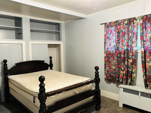 bedroom featuring dark parquet flooring and radiator