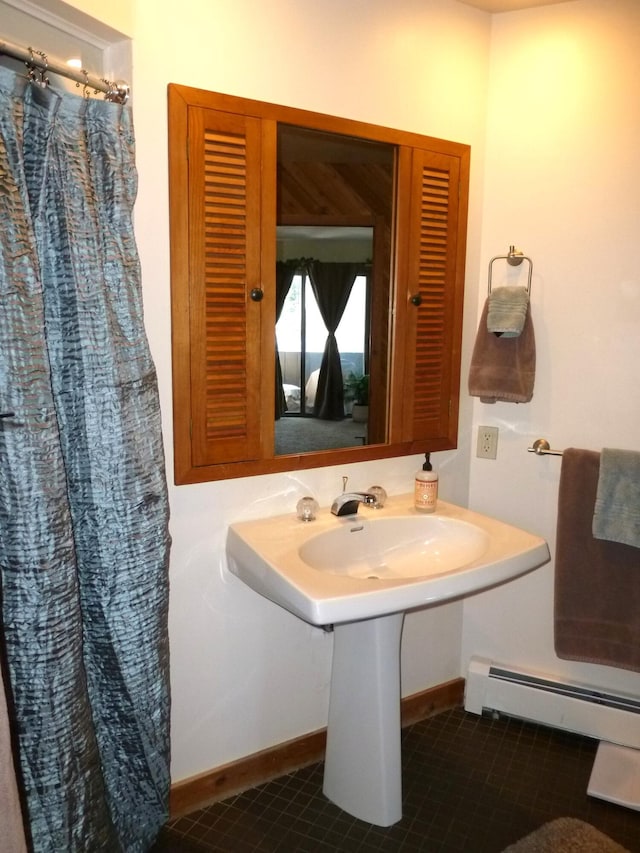 bathroom with baseboard heating, tile patterned floors, and a shower with shower curtain