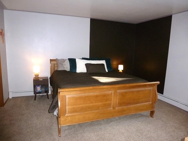 carpeted bedroom with a baseboard heating unit