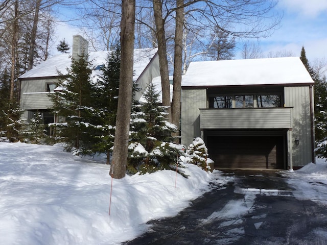 view of snow covered exterior with a garage