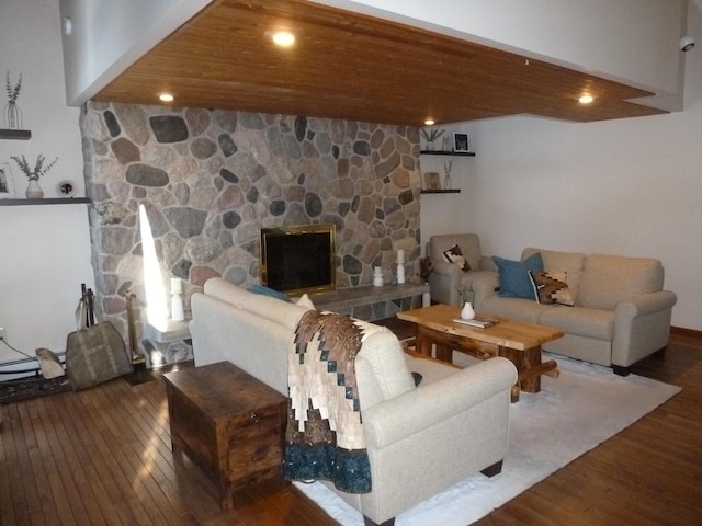 living room featuring a fireplace, wooden ceiling, and wood-type flooring