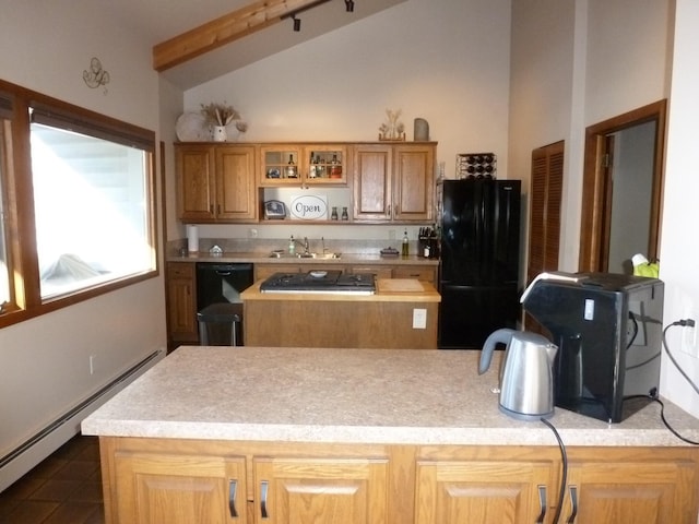 kitchen with sink, dark tile patterned floors, a baseboard heating unit, vaulted ceiling with beams, and black appliances