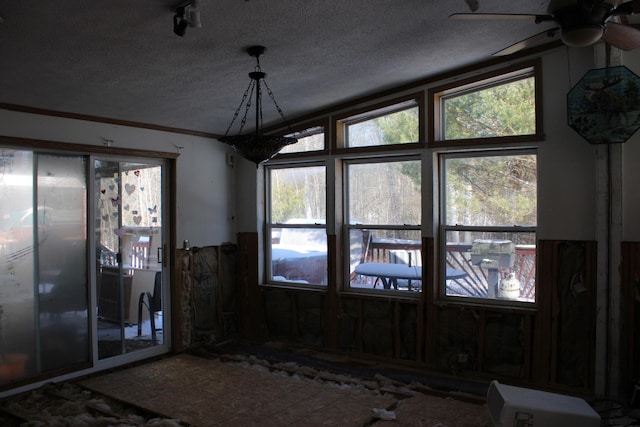 interior space featuring ceiling fan and a textured ceiling